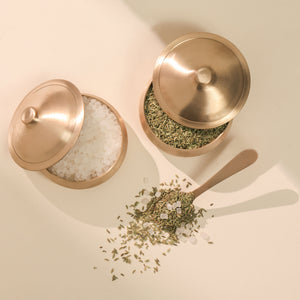 Two gold containers with lids