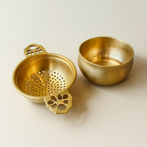 Two gold-colored kitchen utensils